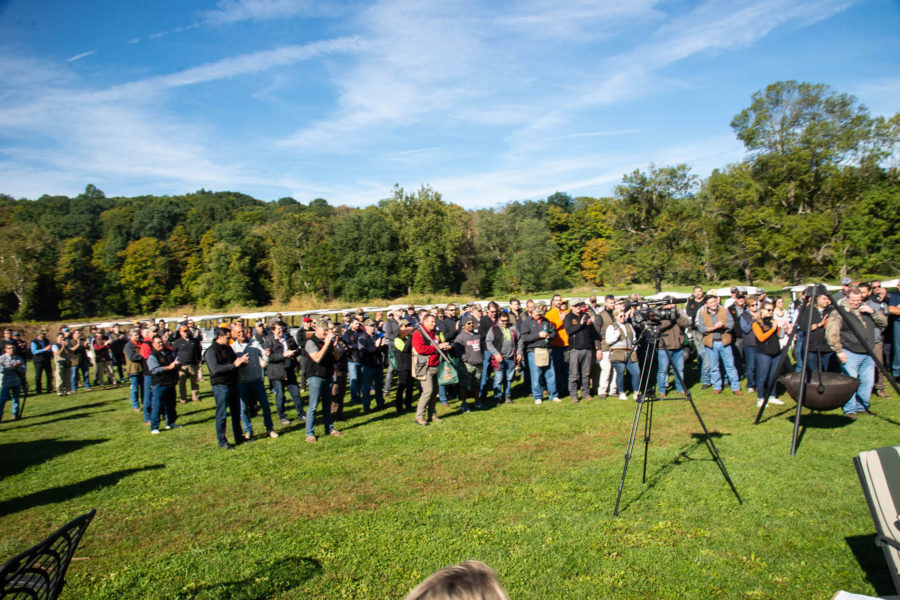 Crowd of photographers with tripods in field