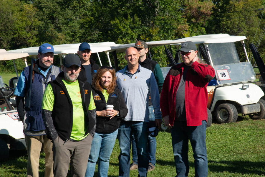 Group of people standing near golf carts