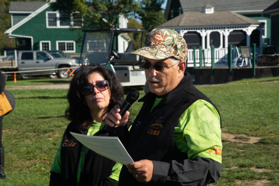 Man with microphone and woman at event