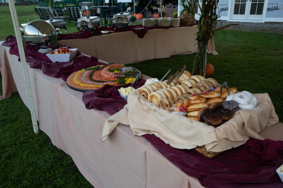 Outdoor buffet table with bagels and pastries