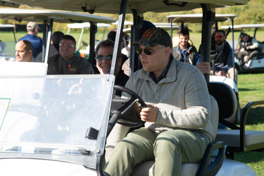Group of people riding golf carts