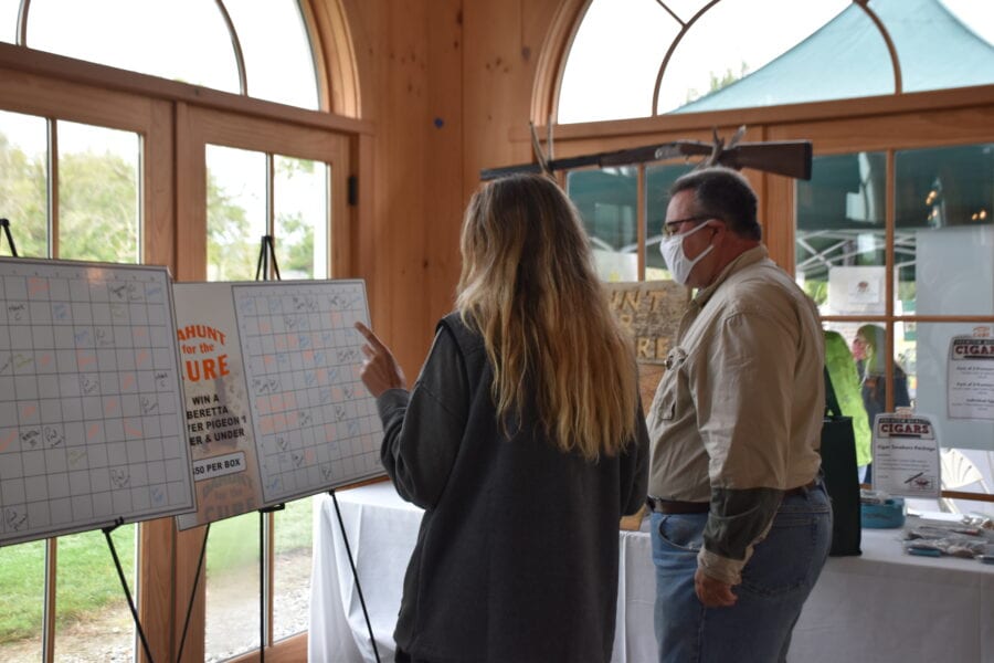 Two people viewing display boards indoors