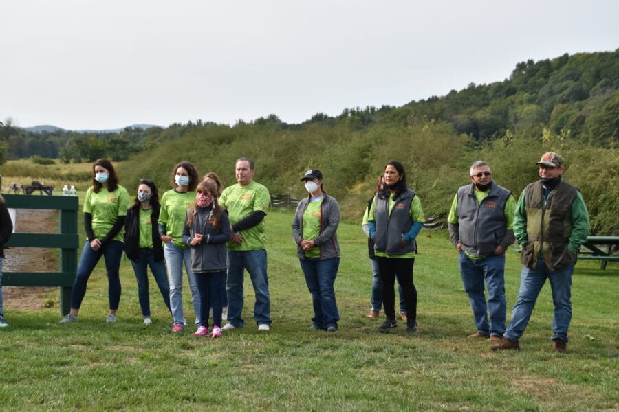 Group of volunteers wearing green shirts outdoors
