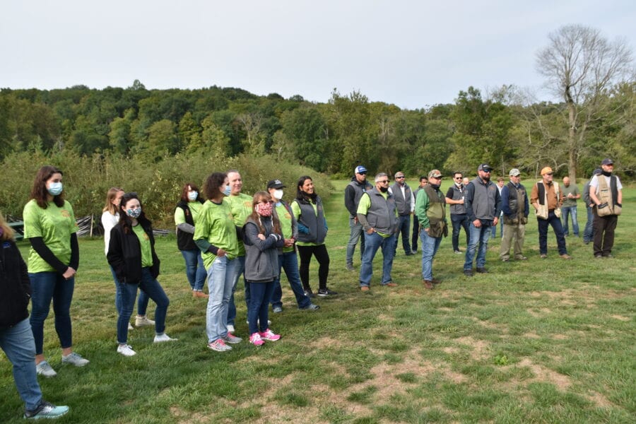 Group of people standing in grassy field