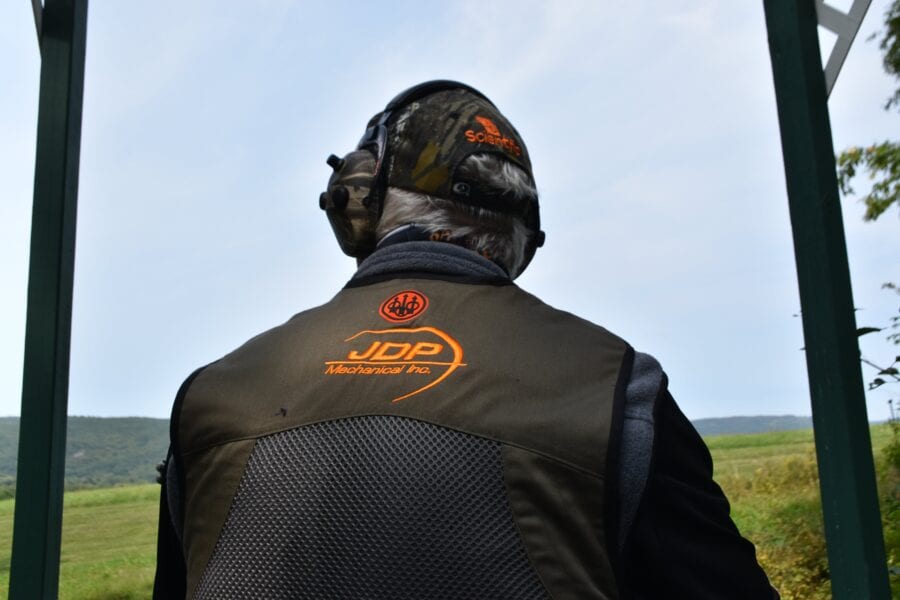 Person wearing shooting vest and ear protection