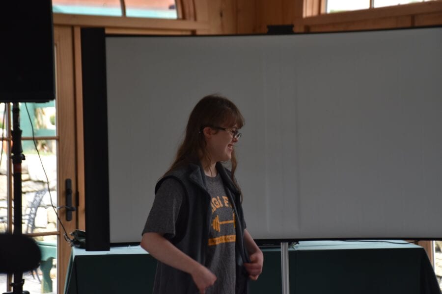 Person standing in front of projector screen