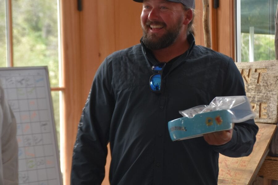 Smiling man in cap holding wrapped cake