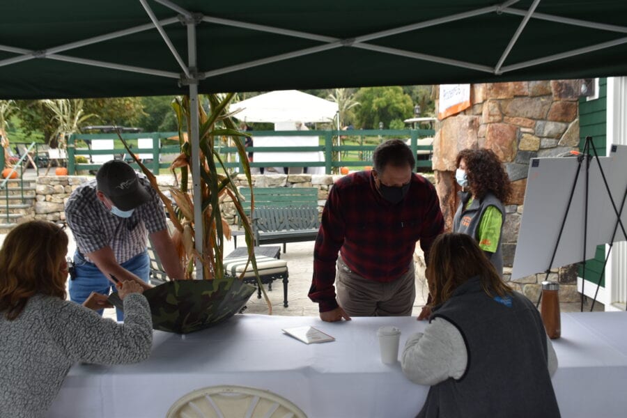 Masked volunteers at outdoor registration table