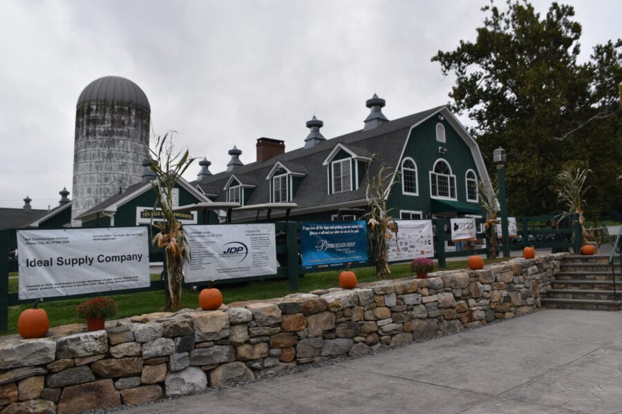 Green barn with silo, pumpkins and banners