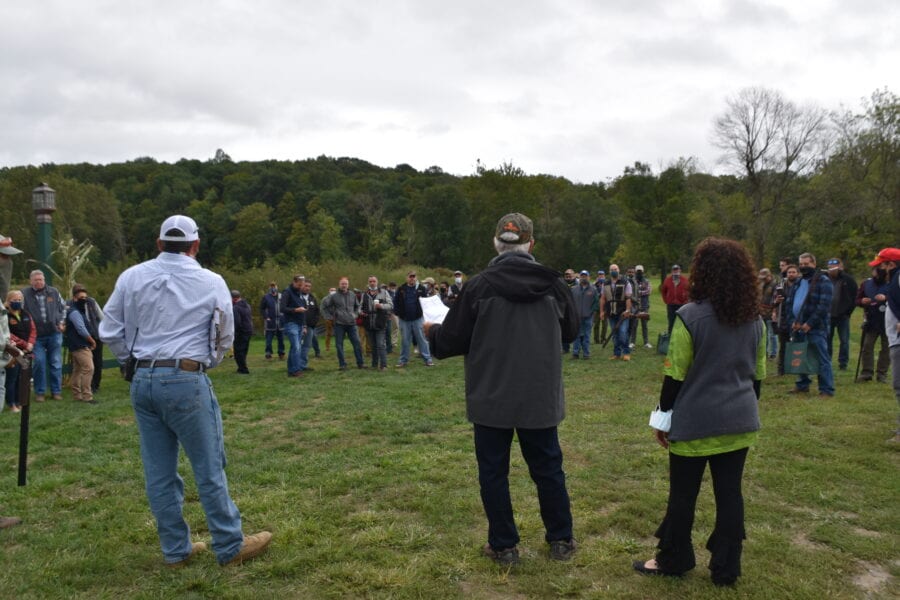 Outdoor gathering with speakers addressing a crowd