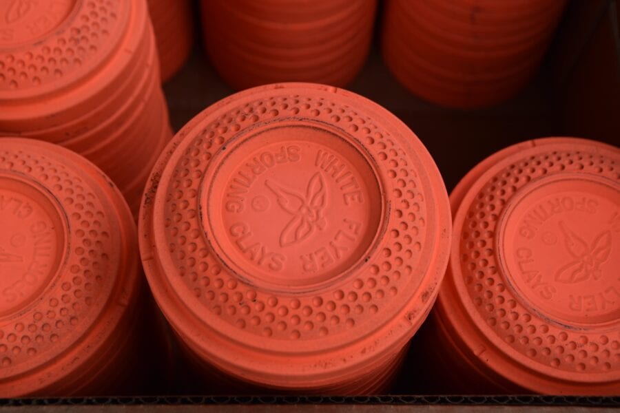 Stacked orange clay pigeon targets