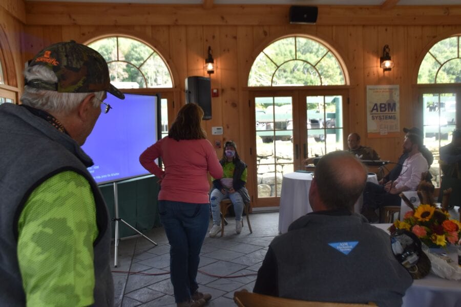 Group meeting in wooden room with projector