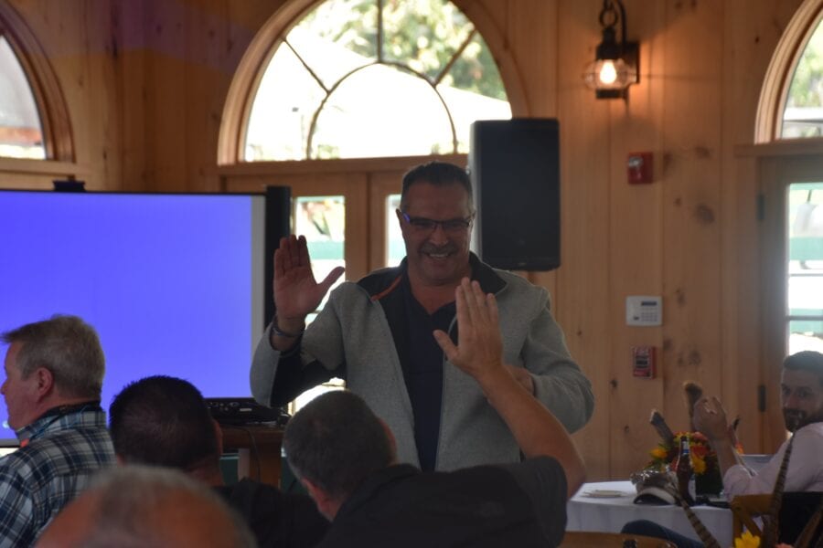Smiling man high-fiving audience at event