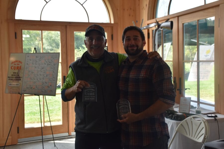 Two men holding awards and smiling