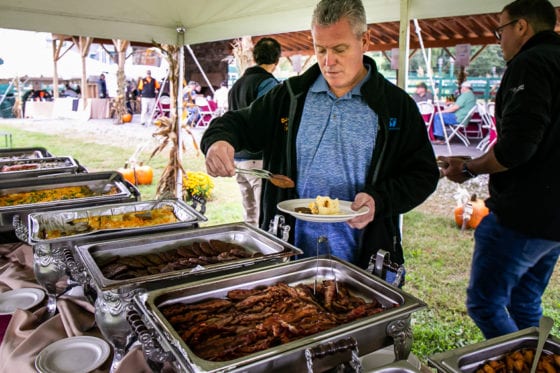 Man serving himself at outdoor buffet