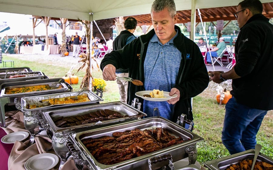 Man serving himself at outdoor buffet