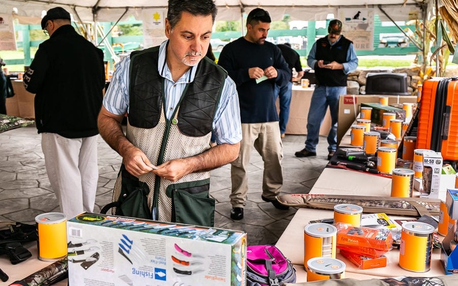 Customers browsing products at outdoor market stall