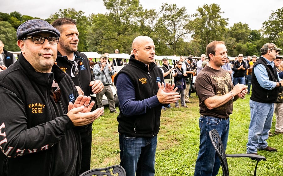 Men applauding at outdoor community event