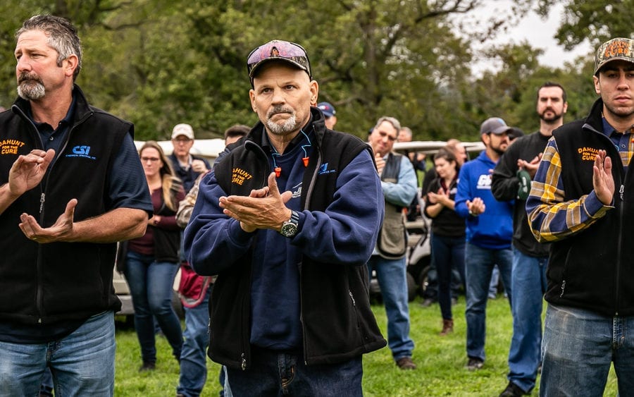 Group of people clapping outdoors